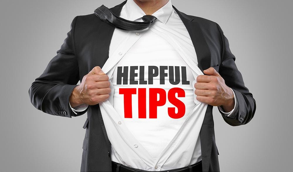 The image features a man in a suit holding up a sign with the text  HELPFUL TIPS  and  SUPEMAN  written on it, suggesting he is presenting advice or strategies.