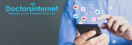 The image is a screenshot of a website with a focus on healthcare services. It features a smartphone displaying social media icons and a graphic of a hand holding a tablet, both surrounded by floating social media symbols. The background is a gradient of blue to gray, and there s text that reads  DOCTORSPINET.COM  at the top and  Helping local patients find you  below the phone and tablet graphics.