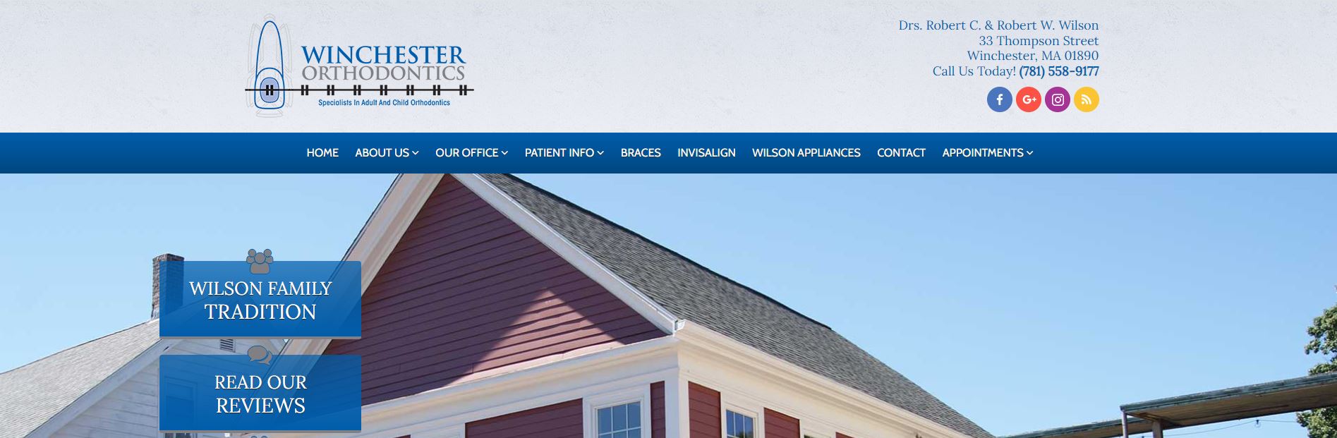 The image shows a webpage screenshot of a real estate listing featuring a house with red siding and white trim, a gray roof, and a front yard with a lawn. There is a blue sky in the background, and the website includes text and navigation elements typical of a real estate site.