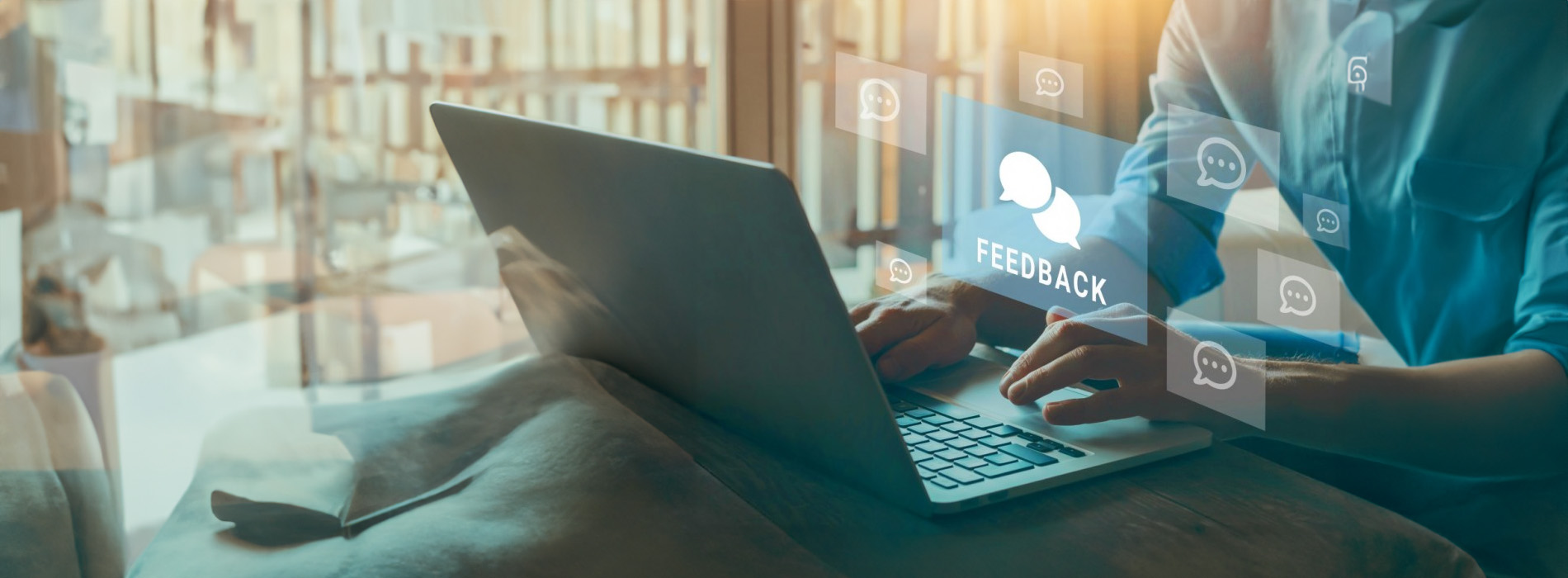 A person using a laptop with a virtual meeting interface displayed on the screen.