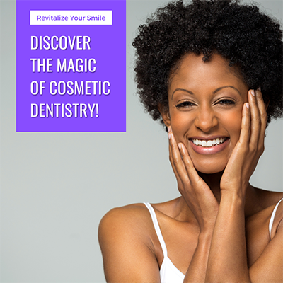 An image of a woman with dark skin, smiling broadly at the camera. She has short hair and is wearing makeup. The background is plain and does not distract from her.