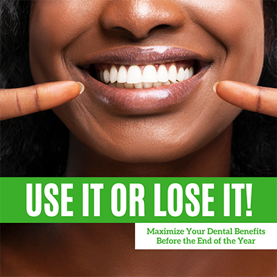 The image features a smiling person with their teeth showing, holding up a finger and thumb as if to emphasize the importance of dental care. A banner across the top of the image reads 'USE IT OR LOSE IT!' followed by text that suggests the image is part of a marketing campaign for dental benefits, indicating that the message is about maintaining dental health or facing consequences for not doing so. The text on the bottom left corner provides an additional context, stating 'MAXIMIZE YOUR DENTAL BENEFITS BEFORE THE END OF THE YEAR.